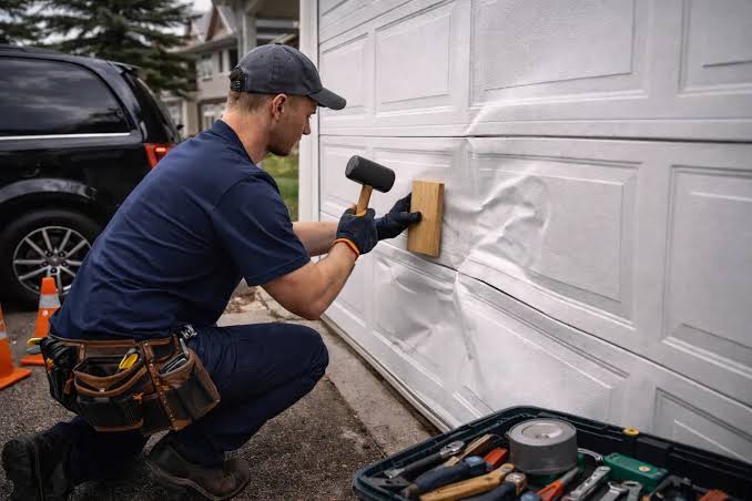 Vehicle impact damage to a garage door panel in Rosharon TX